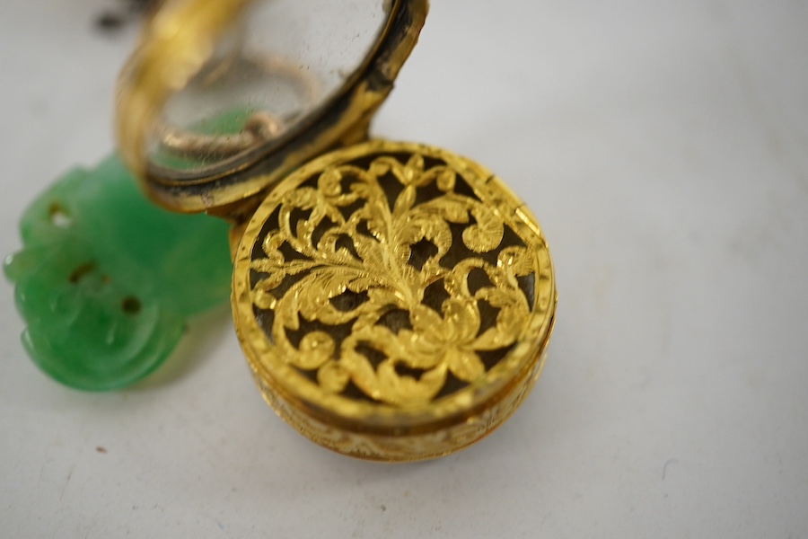 An unmarked yellow metal vinaigrette, 18mm, together with a yellow metal overlaid combination propelling pencil/penknife and a carved jade fob. Condition - fair to good.